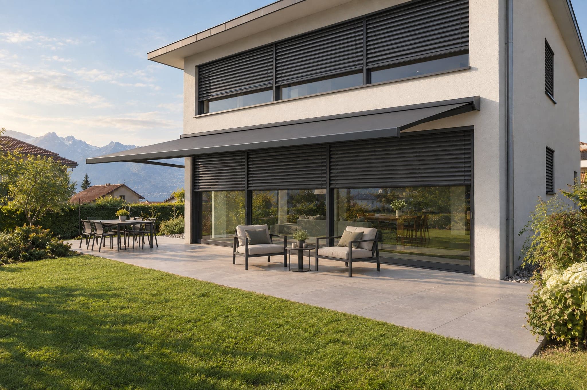 A glass facade shown with anthracite slat blinds and an awning over the terrace